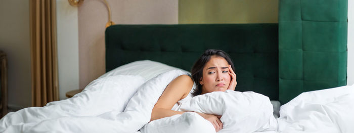 Portrait of woman sleeping on bed at home