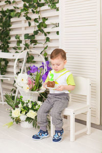 Boy and potted plants on floor