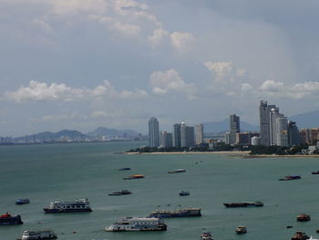 Scenic view of sea and buildings against sky