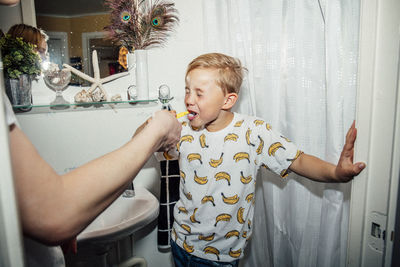 Boy brushing teeth in bathroom