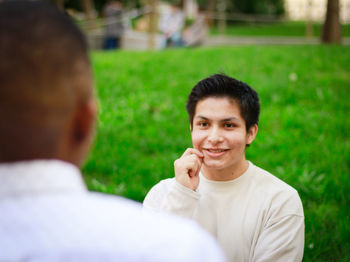 Portrait of smiling young man on grass