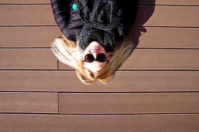 High angle view of woman lying on floorboard