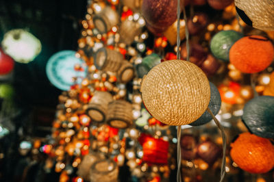 Close-up of christmas decorations hanging at market stall