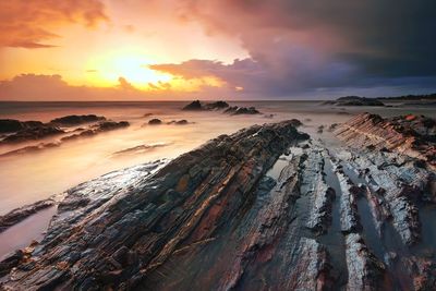 Panoramic view of beach against sky during sunset