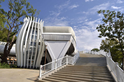 Low angle view of staircase by building against sky