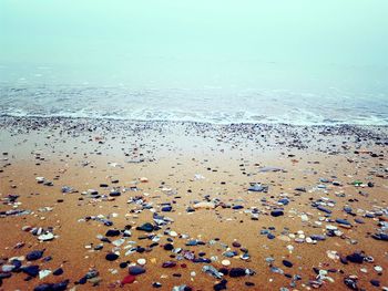 High angle view of pebbles on beach against sky