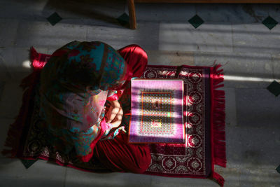 Rear view of woman standing against wall