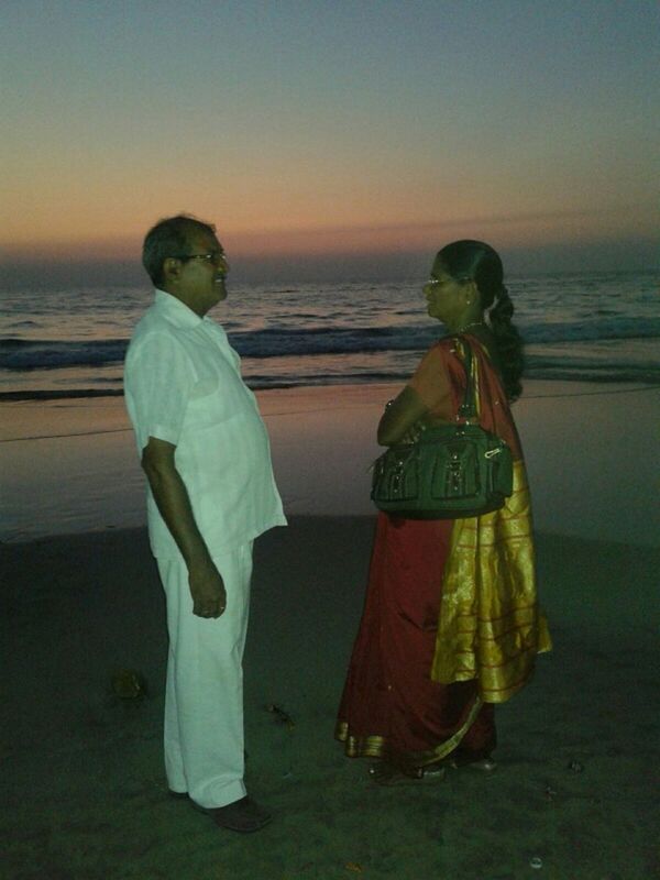 REAR VIEW OF FRIENDS STANDING ON BEACH