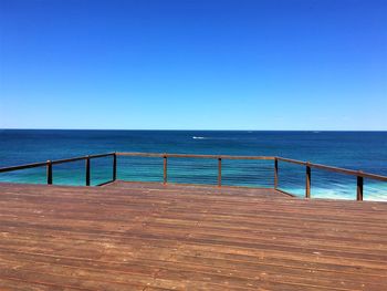 Scenic view of sea against clear blue sky