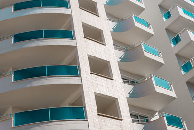 Background image of a part of the facade with balconies and windows. 