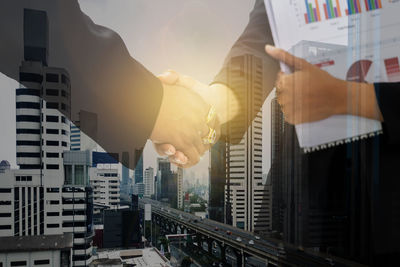 Low angle view of man and buildings in city