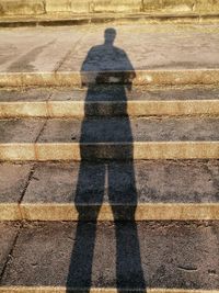 Shadow of person on footpath