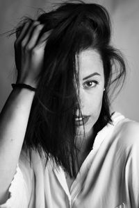 Close-up portrait of beautiful woman with hand in hair