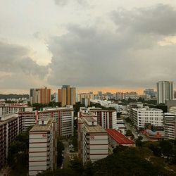 Buildings against cloudy sky