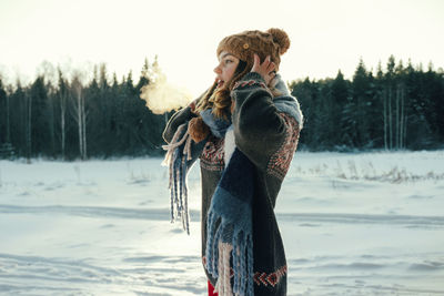 Rear view of woman standing on snow