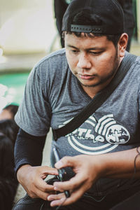 Portrait of young man holding hands