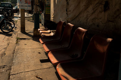 High angle view of abandoned chairs on sidewalk