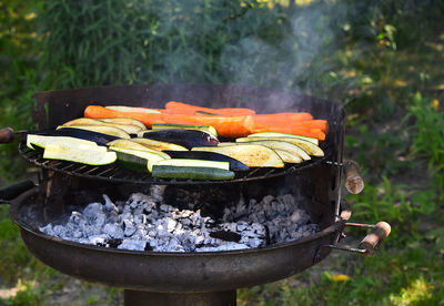 Vegetables cooking on barbecue grill in yard
