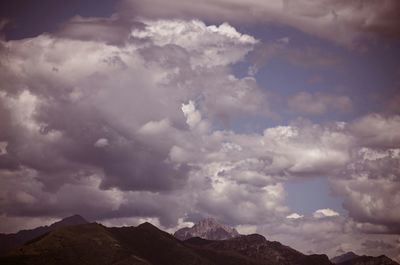 Scenic view of mountains against cloudy sky