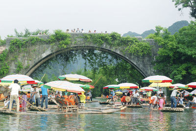 Group of people in river during rainy season