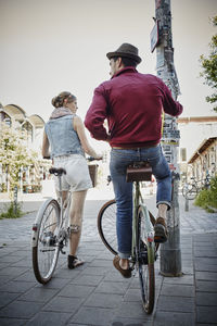 Germany, hamburg, st. pauli, couple exploring the city on their bicycles