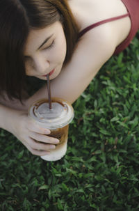 Woman drinking coffee on field
