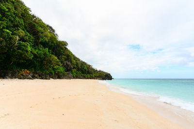 View of calm beach against the sky