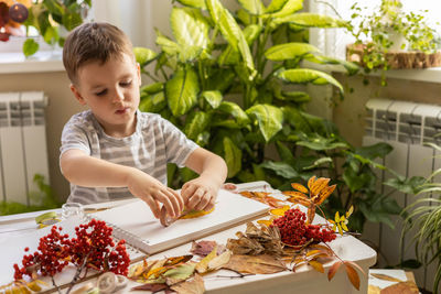 Portrait of boy eating food at home