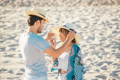 Young couple standing at beach