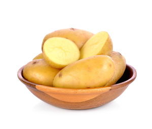 Close-up of fruits in bowl against white background