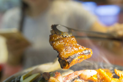 Close-up of serving fish on barbecue grill