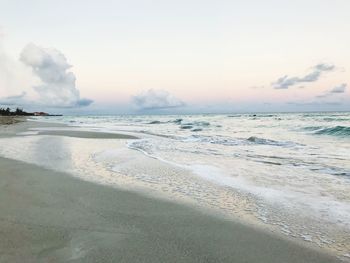 Scenic view of beach against sky during sunset