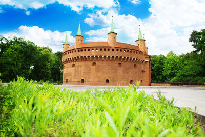 View of castle on field against sky