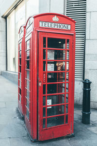 Red telephone booth in city