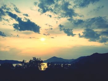 Scenic view of silhouette mountains against sky at sunset