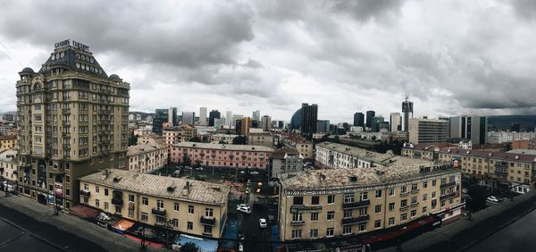 Cityscape against cloudy sky