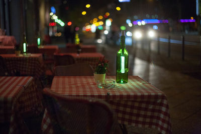 Illuminated table and chairs at night