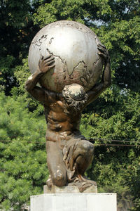 Close-up of statue against plants in park