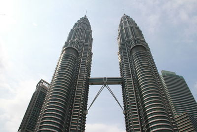 Low angle view of petronas twin tower against sky