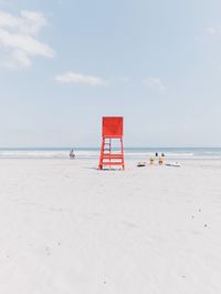 Lifeguard hut at beach against sky