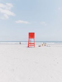 Lifeguard hut at beach against sky