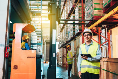 Full length portrait of a man working on building