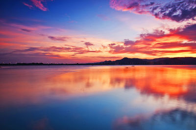 Scenic view of lake against dramatic sky