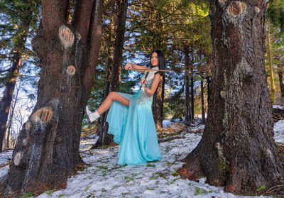 Woman playing on violin in the forest
