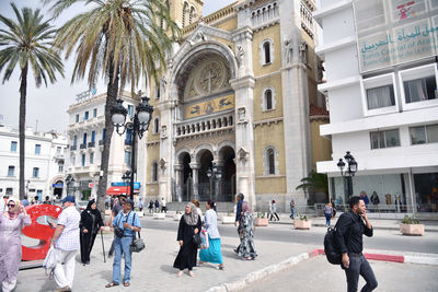 Group of people walking in front of building