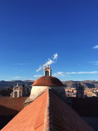 Houses in town against blue sky