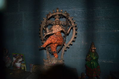 Nataraja statue against wall at home