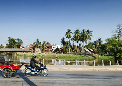 Man riding bicycle on road