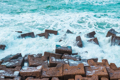 High angle view of groyne on beach