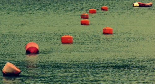 High angle view of buoys floating on water in lake